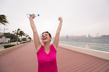 Image showing young woman celebrating a successful training run