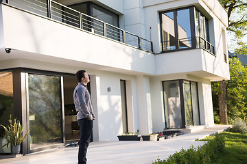 Image showing man in front of his luxury home villa