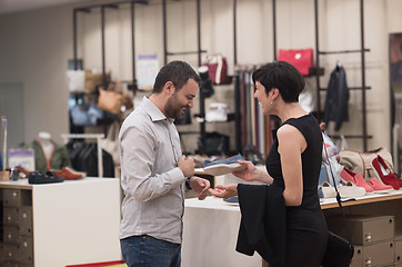 Image showing couple chooses shoes At Shoe Store