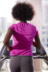 Image showing afro american woman running on a treadmill