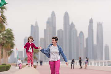 Image showing mother and cute little girl on the promenade
