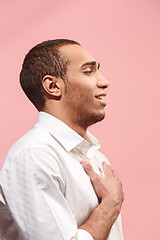 Image showing The happy businessman standing and smiling against pink background.