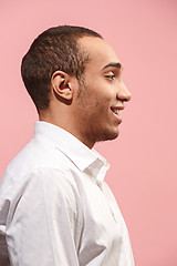 Image showing The happy businessman standing and smiling against pink background.