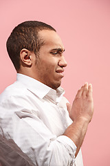 Image showing Let me think. Doubtful pensive man with thoughtful expression making choice against pink background