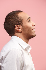 Image showing The happy businessman standing and smiling against pink background.