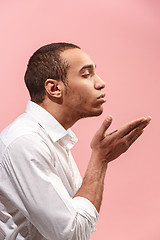 Image showing Portrait of attractive man with kiss isolated over pink background