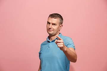 Image showing The serious business man point you and want you, half length closeup portrait on pink background.