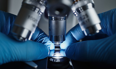 Image showing Scientist hands with microscope