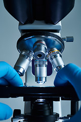 Image showing Scientist hands with microscope