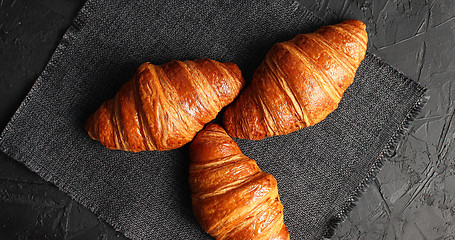 Image showing Golden baked croissants on napkin