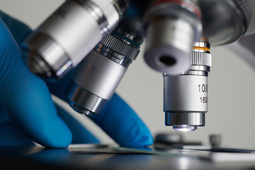 Image showing Scientist hands with microscope