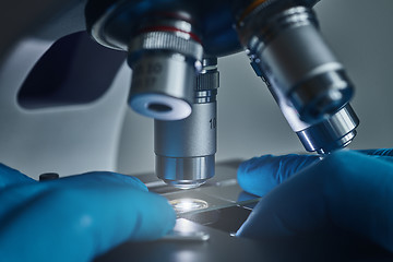 Image showing Scientist hands with microscope