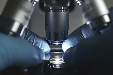 Image showing Scientist hands with microscope