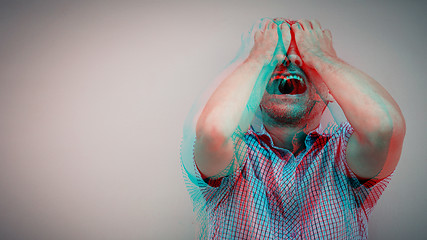 Image showing one sad man standing near a  wall and covers his face