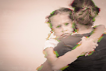 Image showing Portrait of a sad daughter hugging his mother.