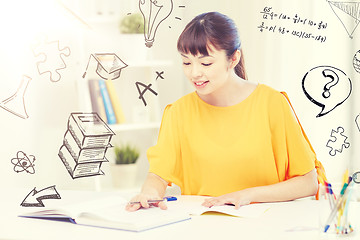 Image showing happy asian young woman student learning at home