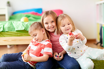 Image showing kids with modelling clay or slimes at home