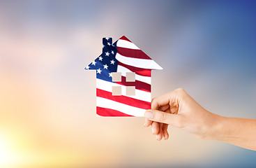 Image showing hand holding paper house in colors of american flag