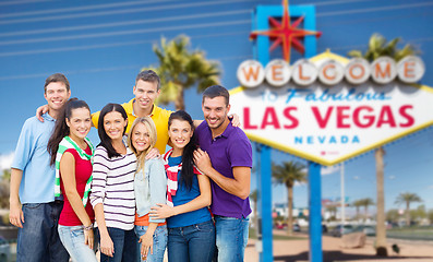 Image showing happy friends over welcome to las vegas sign