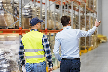 Image showing businessman showing warehouse to worker