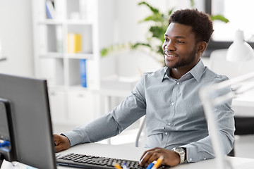 Image showing african businessman with computer at office