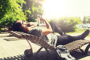 Image showing man with smartphone and earphones listening music