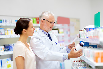 Image showing apothecary and woman with drug at pharmacy