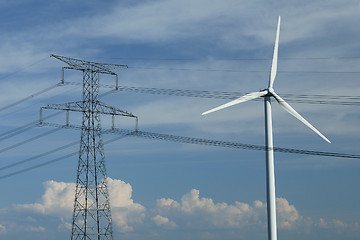 Image showing a windturbine close to a electric pylon