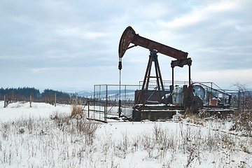 Image showing Oil well on a winter landscape