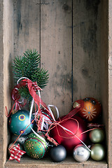 Image showing Christmas decoration glass balls in a wooden box background
