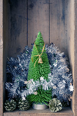 Image showing Christmas decoration golden bell jar and tree in a wooden box ba