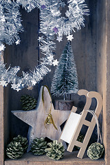 Image showing Christmas decoration golden bell jar, sledge, star and tree in a