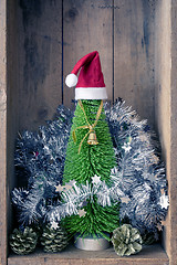 Image showing Christmas decoration golden bell jar and tree in a wooden box ba