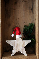 Image showing Christmas decoration Santa Clause hat on a star in a wooden box 