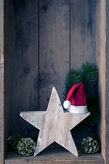 Image showing Christmas decoration Santa Clause hat on a star in a wooden box 