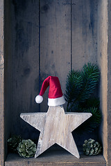 Image showing Christmas decoration Santa Clause hat on a star in a wooden box 