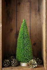 Image showing Christmas decoration pinecone and tree in a wooden box backgroun