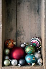 Image showing Christmas decoration glass balls in a wooden box background