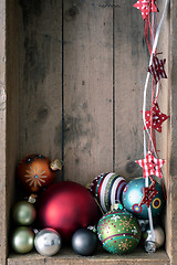 Image showing Christmas decoration glass balls in a wooden box background