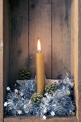 Image showing Christmas decoration orange bee wax candle in a wooden box backg