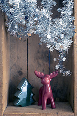 Image showing Christmas decoration deer and tree figure in a wooden box backgr
