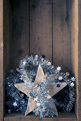 Image showing Christmas decoration wooden star in a wooden box background