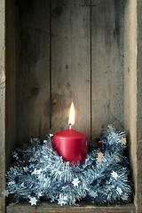 Image showing Christmas decoration red candle in a wooden box background