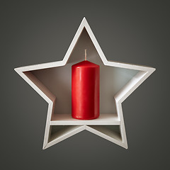 Image showing Christmas decoration white star with red candle inside