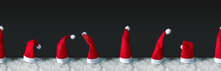 Image showing seamless row of red Santa Claus hats