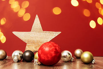 Image showing Christmas decoration glass balls with wooden star and bokeh ligh