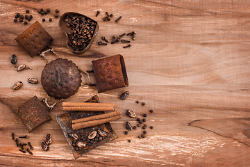 Image showing Spices in rusty metal plates on wooden background
