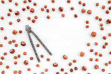 Image showing Nutcracker and hazelnuts on white background with copy space