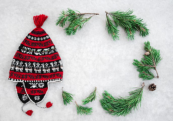 Image showing Red winter hat and green pine branches