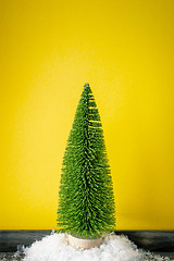 Image showing Christmas decoration a fir trees in front of a yellow background